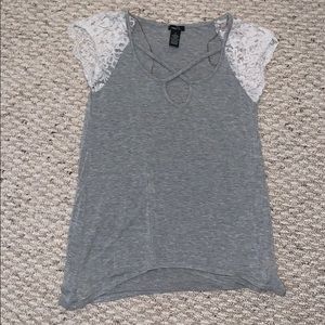 grey blouse w/ white laced sleeves and cross front